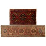 A muted red ground North West Persian Karadja runner with a typical geometric device on a field of