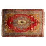 An old red-ground Turkish Ushak rug with central stepped medallion within broad borders, 1.3 mtrs