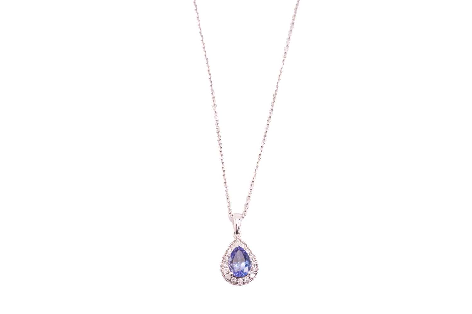 A tanzanite and diamond cluster pendant on chain, featuring a pear-shaped tanzanite of 8.3 x 5.6 mm,