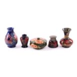 Five pieces of Moorcroft pottery, comprising a Pomegranate pattern inkwell, with plated hinged