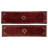 Two similar red-ground modern Hussainabad (Hamadan) strip runners with a single-stepped lozenge on a