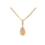 A citrine pendant on chain, comprising a pear-shaped citrine of pale orangey-yellow colour,