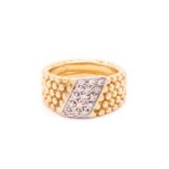 A dress ring with a stripe of 15 pave set diamonds on a textured bead band measuring 10mm tapering