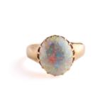 A precious opal dress ring in 18ct yellow gold, composed of an oval precious opal cabochon,