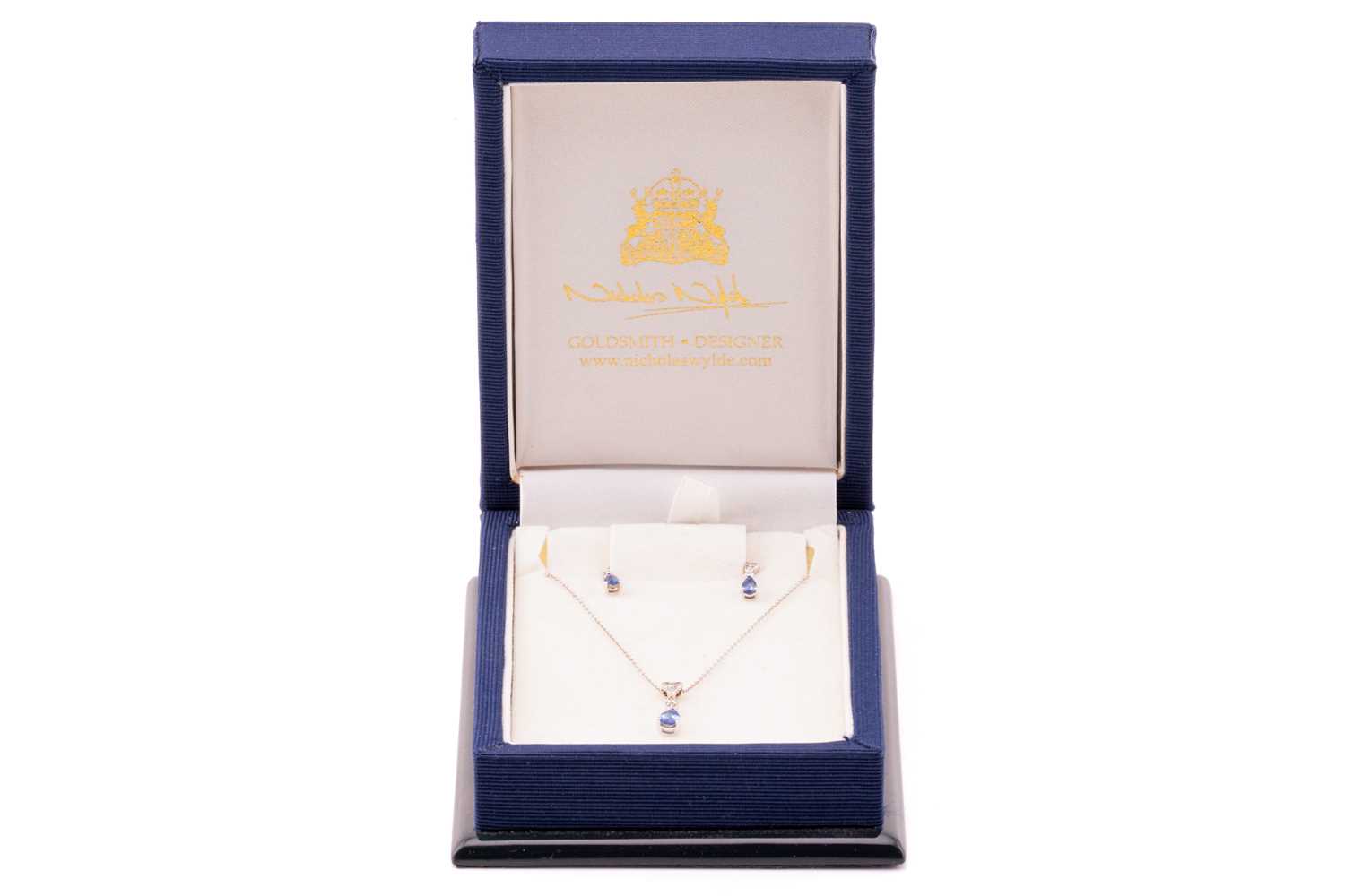 A sapphire and diamond necklace and earrings en-suite; the necklace comprises a pear-shaped sapphire