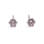 A pair of diamond stud earrings in 18ct white gold, each featuring a round brilliant diamond in a