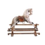 An early 20th century dapple grey Rocking Horse, with white hair mane and tail, leather saddle and