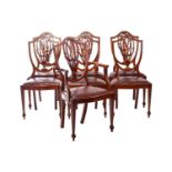 A set of seven Heppelwhite style inlaid mahogany shield-back dining chairs, early 20th century,