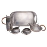 An Arts & Crafts "Tudric" pewter for Liberty & Co four piece tea set and tray, designed by Archibald