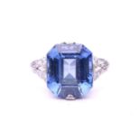 A Belle Epoque sapphire and diamond ring; the octagonal, step-cut, cut-cornered sapphire in raised