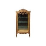 A Louis XVI-style carved and gilt wood single-door standing vitrine/ display cabinet, early 20th