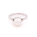 A pearl solitaire ring, featuring a natural pearl of 7.1 x 7.3 x 8.5 mm, set in a flower mount, to a