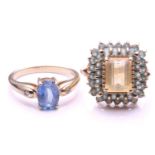 A pale sapphire ring; the oval cut sapphire in four claw mount, the tapering shoulders set with