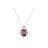 A large amethyst pendant on chain, contains an octagonal step-cut amethyst of 19.6 x 15.9 x 14.2 mm,