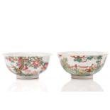 Two Chinese porcelain bowls, one painted with numerous boys playing within a fenced garden, the