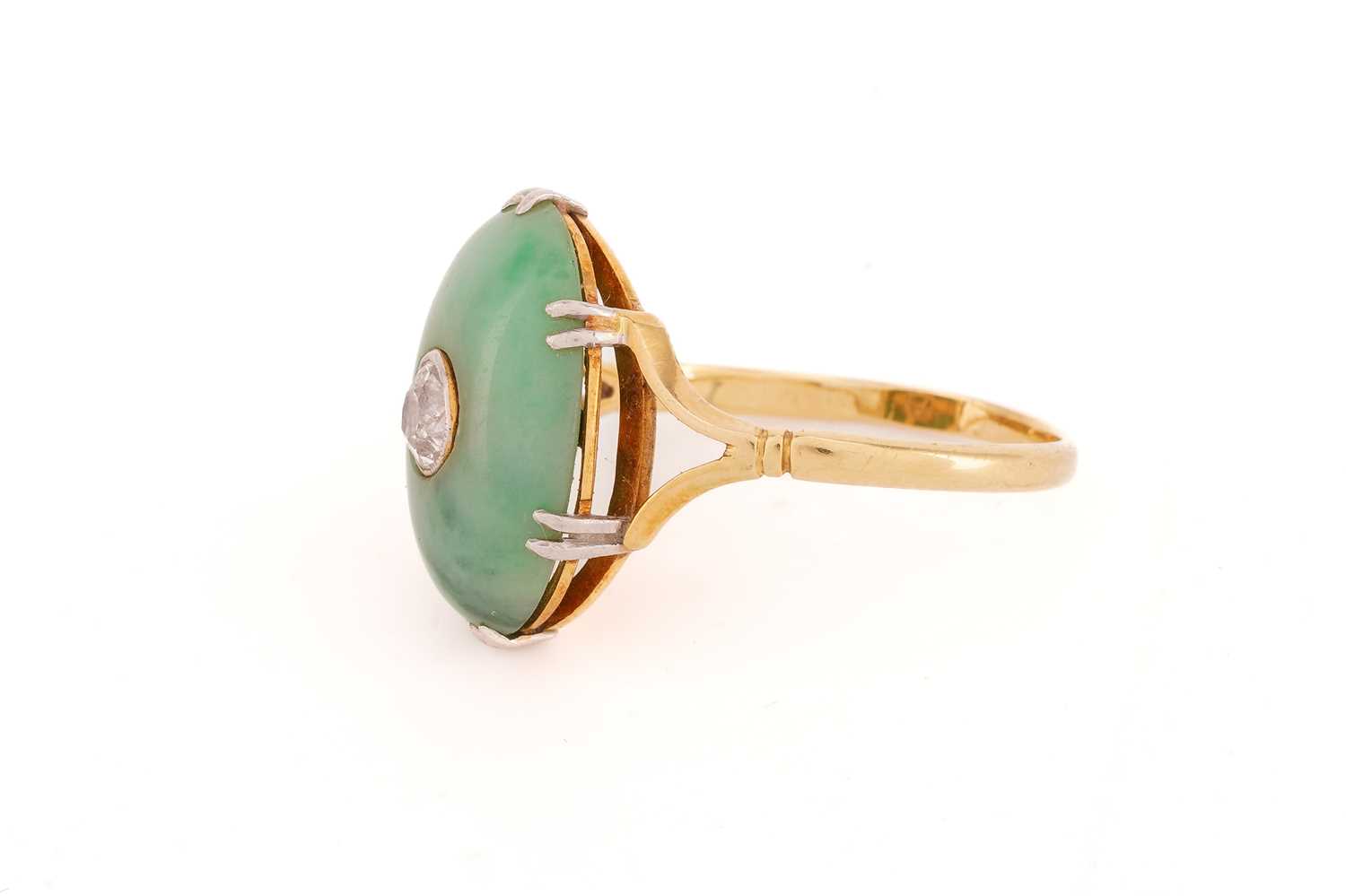 A jade and diamond ring, the oval jade cabochon measuring approximately 17 x 12mm, centred by an old - Image 3 of 9