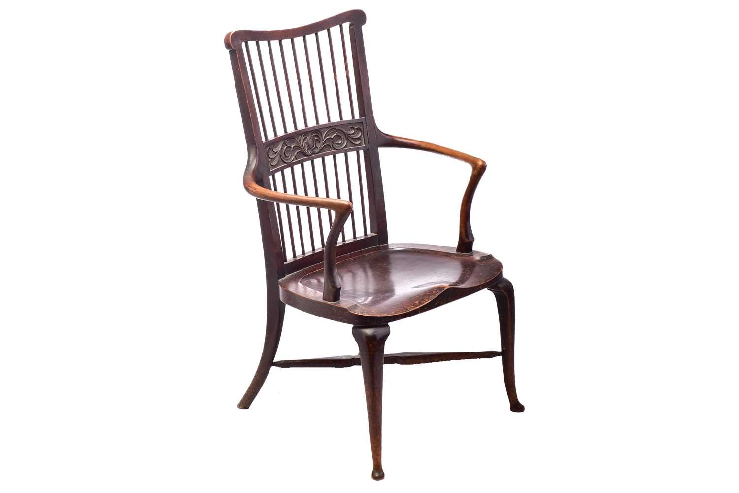 A late 19th/early 20th century spindle back stained mahogany armchair, possibly American, with