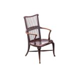 A late 19th/early 20th century spindle back stained mahogany armchair, possibly American, with