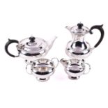 A four piece silver tea service, of circular form with beaded edge and ebony handles, Walker & Hall,