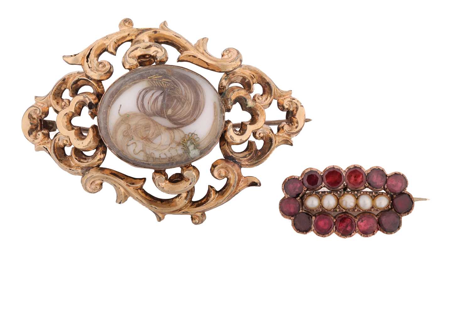Two early 19th-century brooches; including a mourning brooch with a double glass compartment,