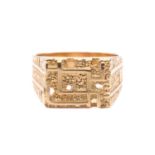 A modernist abstract ring, the rectangular ring head comprises geometrical designs on a textured