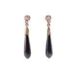 A pair of hematite and diamond pendant earrings, each containing an elongated teardrop-shaped