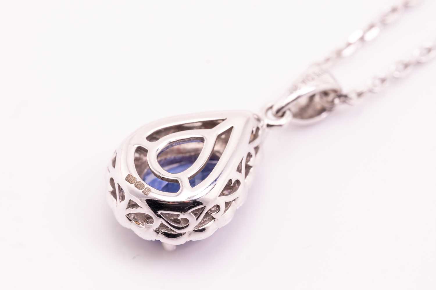 A tanzanite and diamond cluster pendant on chain, featuring a pear-shaped tanzanite of 8.3 x 5.6 mm, - Image 2 of 4