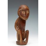 PNG, Massim, carved wooden squatted male figur