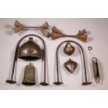 A collections of various African iron currencies and gongs and rattles.