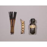 Solomon Islands, wooden comb and Asmat, bone nose ornament.