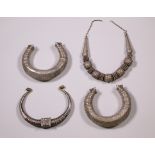 Pakistan-India, a pair of silver bracelets-shakers and two silver necklaces;