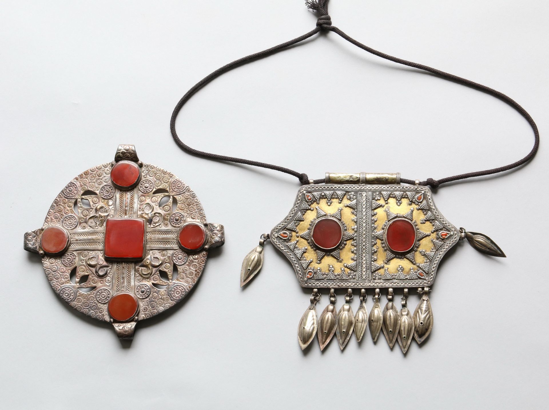 Turkmenistan, Yomud, amulet container and Ersari, round pendant.