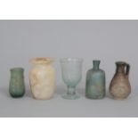 Three glass objects, a faience jar and an albaster pot.