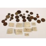 A 19th century collection of eleven Roman bronze copper alloy coins, wrapped in paper with comments