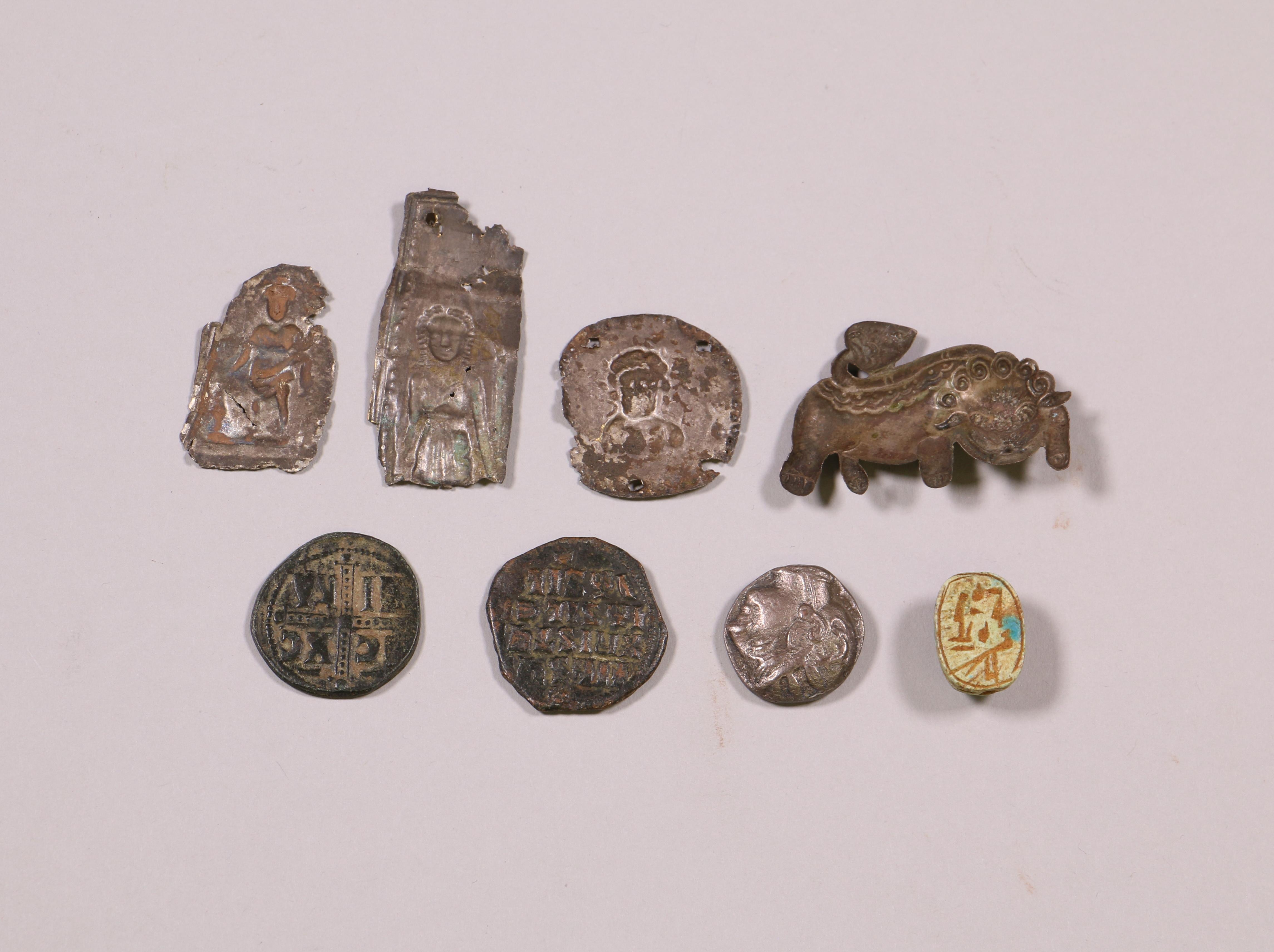 Egypt, faiance scarabe, Late Period, three metal votive plaquettes, a metal relief lion and three co - Image 2 of 2