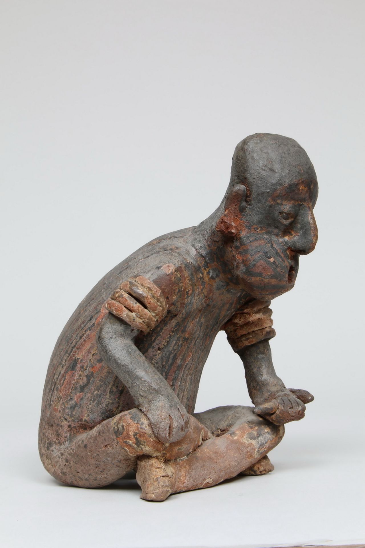 Mexico, Jalisco, a large terracotta seated figure with bent back, 1st BC - 2nd century AD,