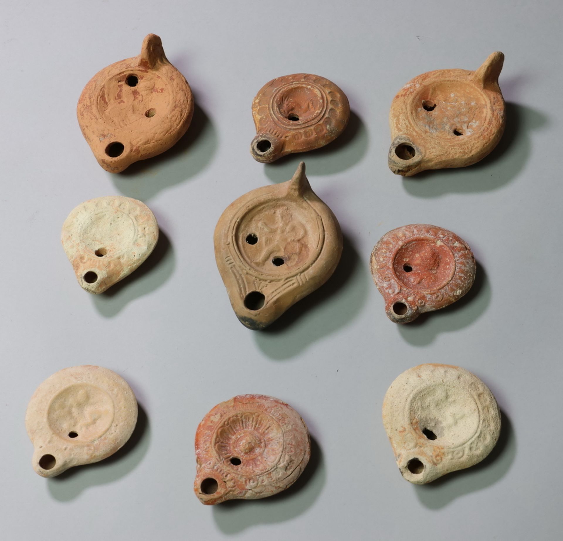 Nine Roman oil lamps, 3rd century AD.