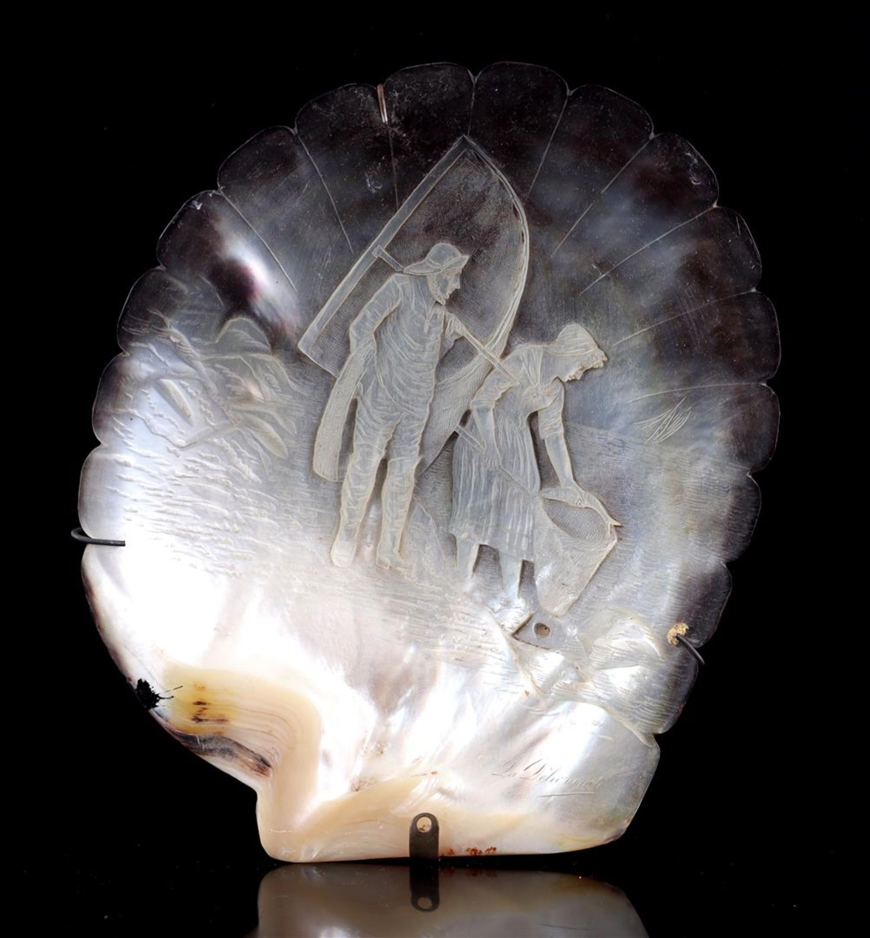 Carved mother-of-pearl shell with a decoration 