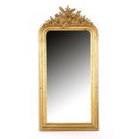 Mirror in gold-coloured wooden frame with richly decorated crest with birds
