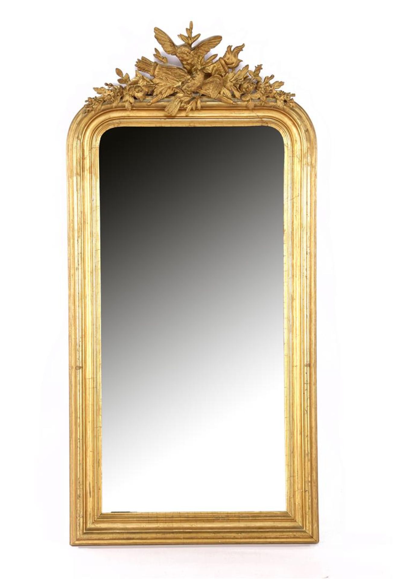 Mirror in gold-coloured wooden frame with richly decorated crest with birds