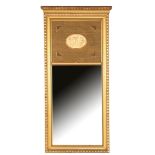 Faceted mirror in gold-coloured decorated frame with oval medallion in the top