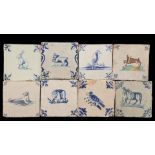 1 polychrome and 7 blue and white colored earthenware tiles