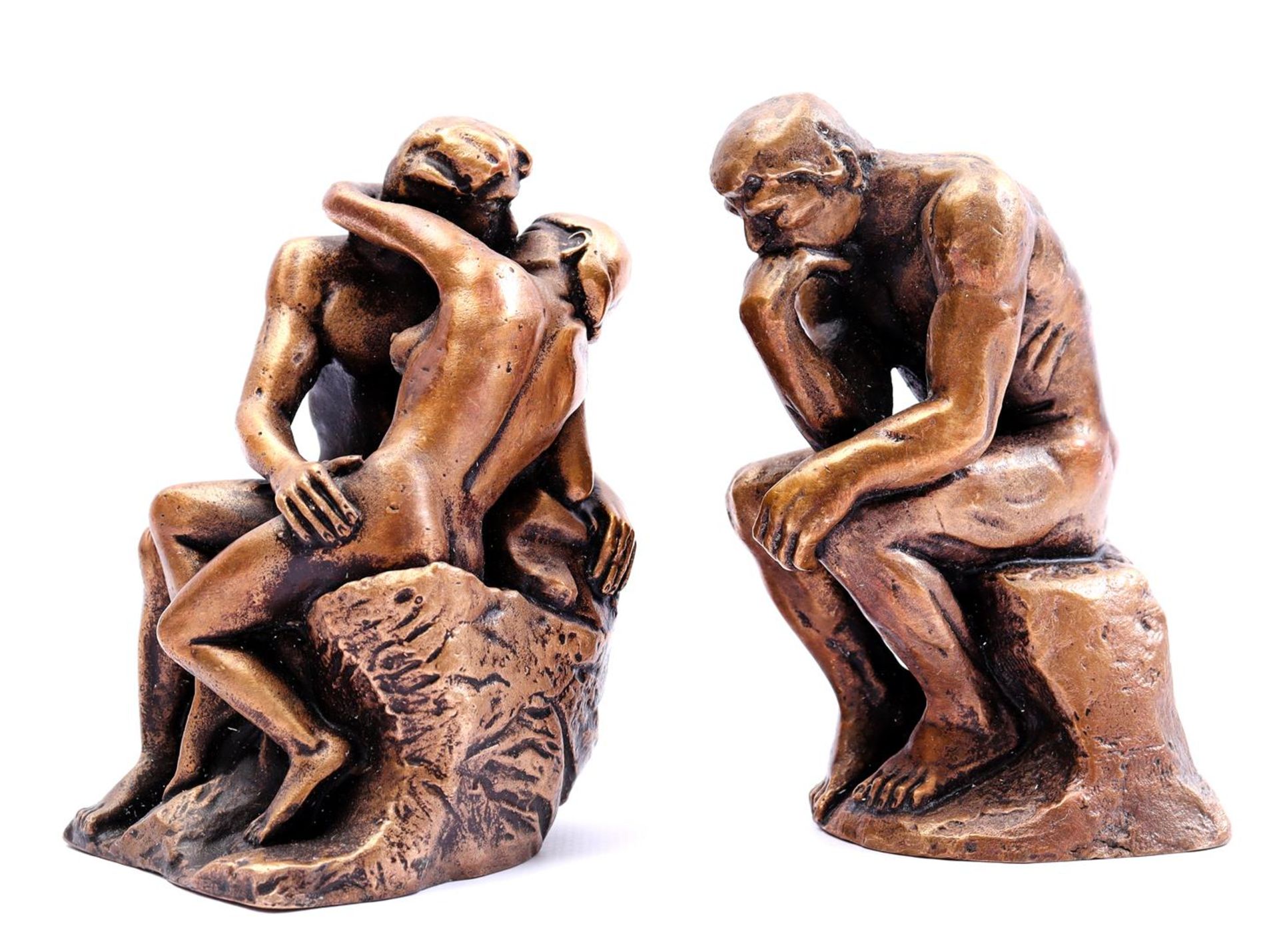 2 bronze sculptures of the thinker and couple in love 