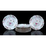 11 Famille Rose porcelain dishes with contoured rim and polychrome flower decor