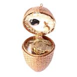 Object in the shape of a wicker egg on a ring