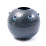 Copper ball vase with blue glass beads, decorated wall
