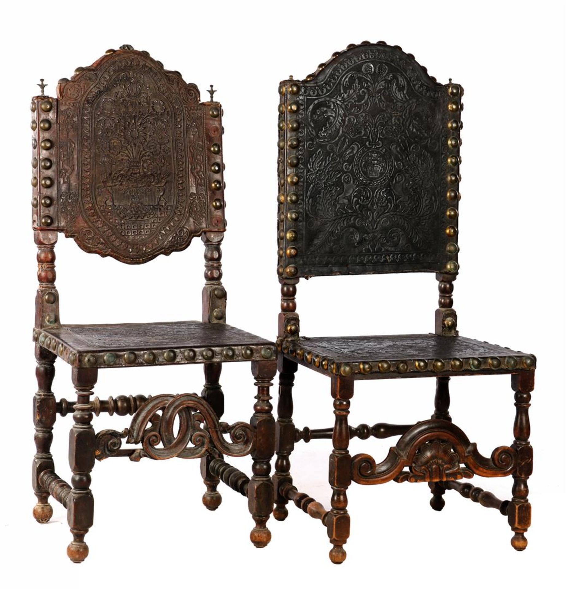 2 richly decorated chairs with richly decorated leather 