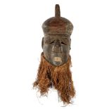 Wooden ceremonial mask decorated with flax