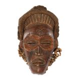 Wooden ceremonial mask decorated with flax and rope