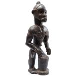 Wooden ceremonial statue of a man with drum